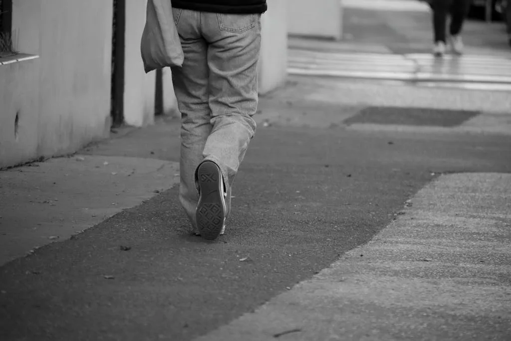 Person walking away on a city street, representing short-term therapy